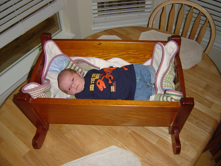 Grant Kish in cradle made by his Great Grandfather, Dennis Kish